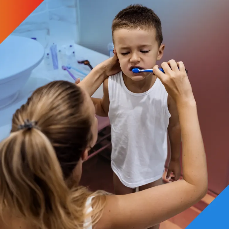 Mom brushing son's teeth