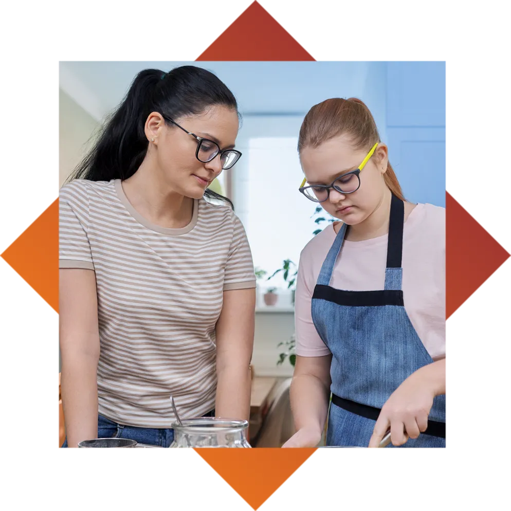 Mother and Daughter cooking together in kitchen